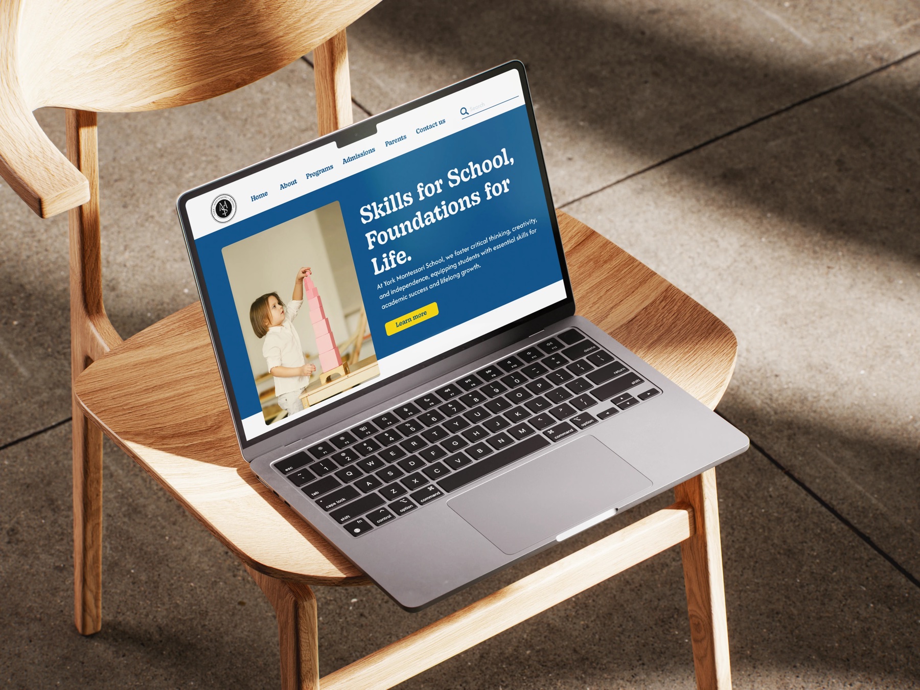 Laptop showing the redesigned York Montessori School homepage